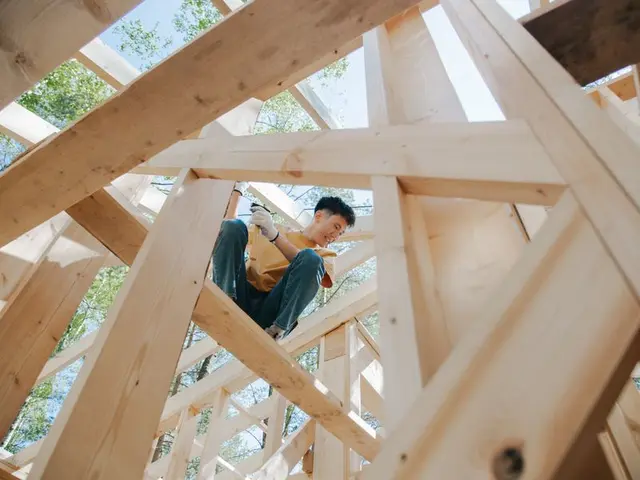Carpenter working on a timber frame at a construction site