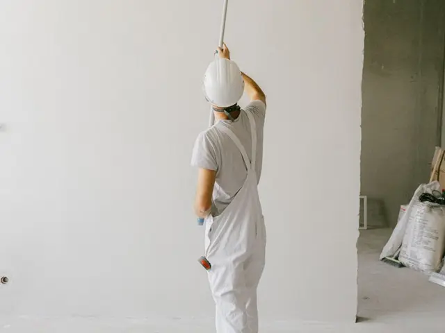 Painter rolling fresh paint on an interior wall